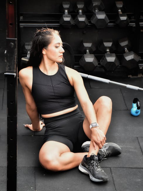 Athlete resting on a gym floor after a workout