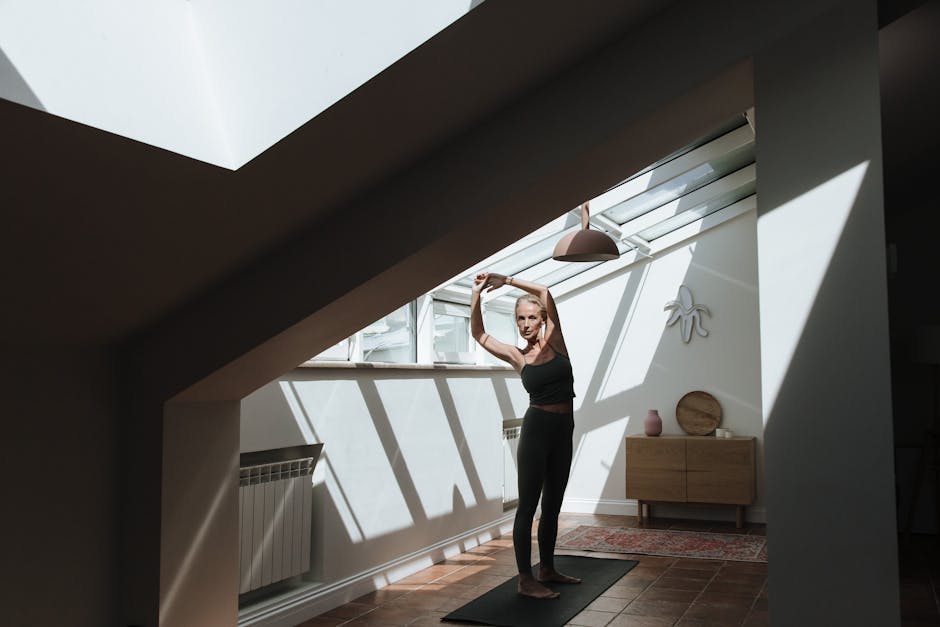 Woman stretching gracefully in a bright, sunlit room
